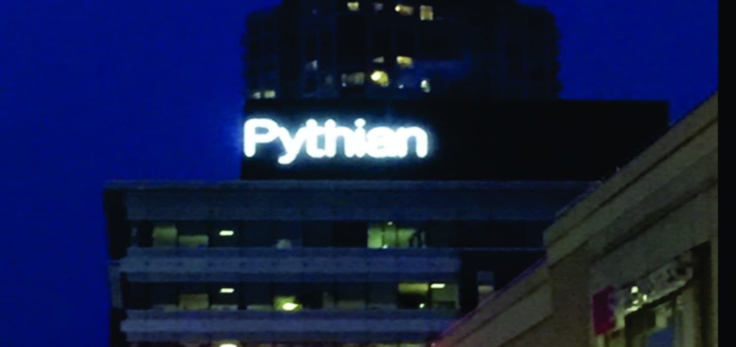 Pythian building illuminated rooftop channel letters at night, Ottawa