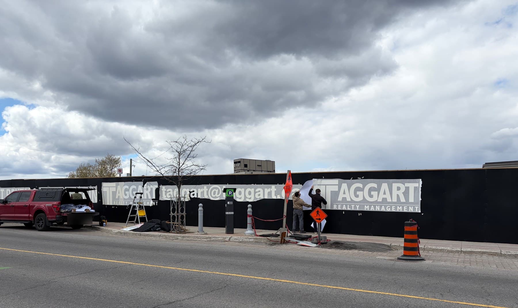 Vinyl graphics installation on construction hoarding, Preston Street, Ottawa