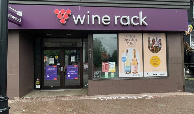 Wine Rack retail storefront wide view with fascia sign and entrance