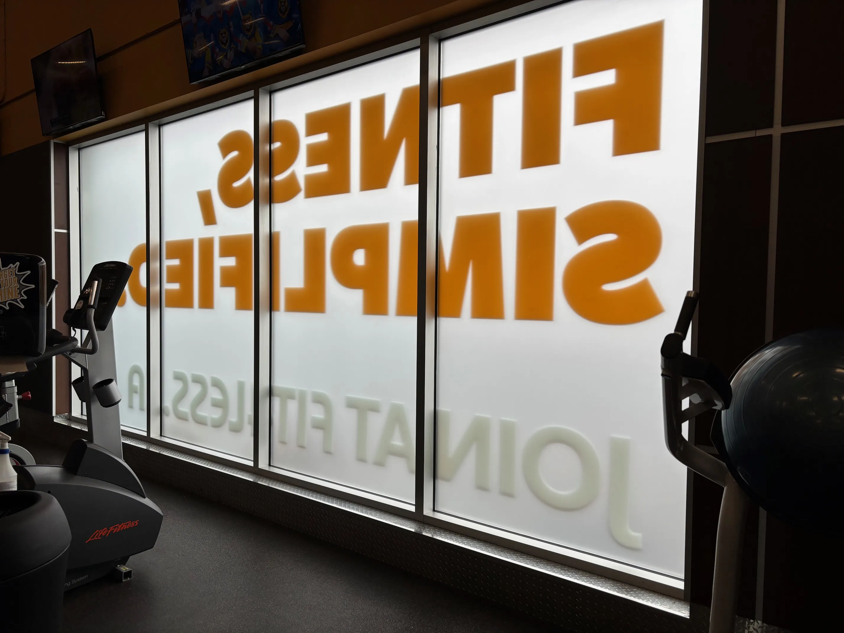 Fit4Less after — "Proudly Canadian" maple leaf window graphics